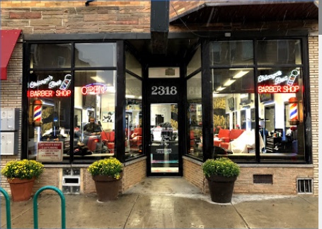 Chicago's Best storefront with 2318 above the door and red barber shop neon